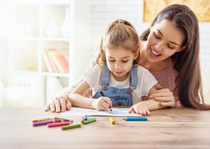 Woman and child coloring together