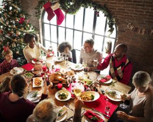 Family gathers for Christmas dinner at table