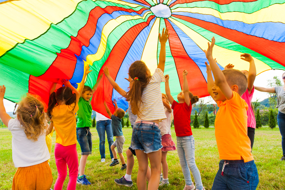 Kids Playing With Colorful Parachute