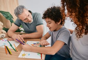 Parents drawing with their child with autism