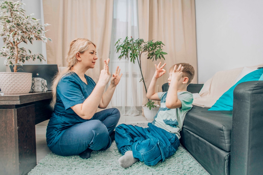 Behavior technician and child working on social skills training