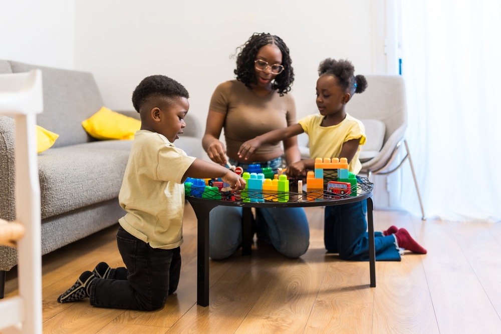 Happy family playing with blocks in a living room