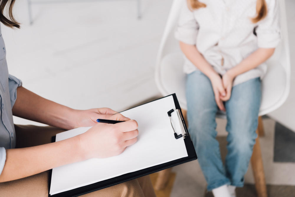 Psychologist and child being diagnosed with autism