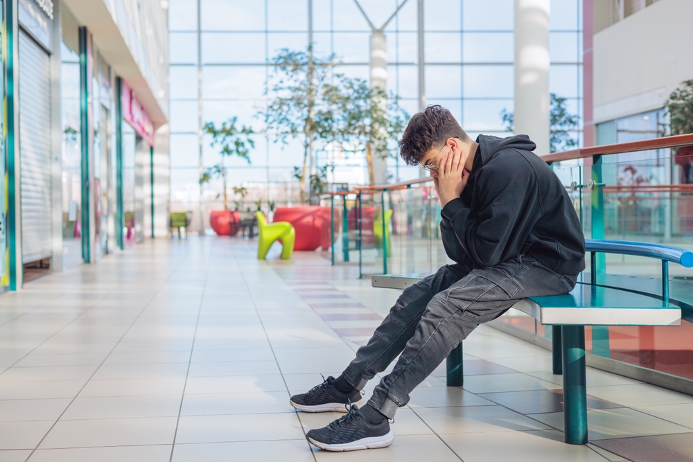 Teenager overstimulated before a meltdown at a mall